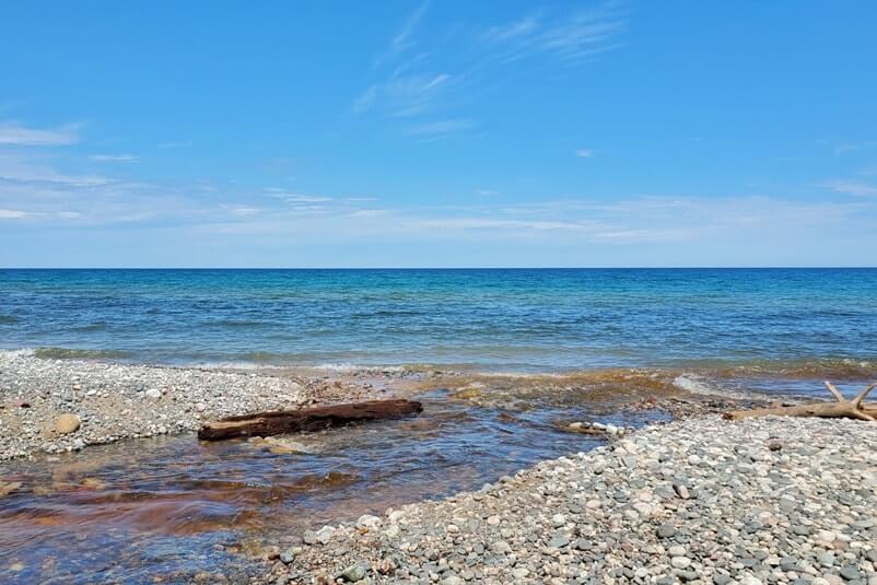 Sable Falls waterfalls river to Lake Superior beach in Pictured Rocks. UP Michigan travel blog