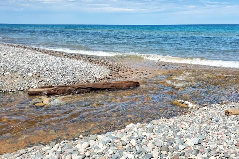 Sable Falls waterfalls river to Lake Superior beach in Pictured Rocks. UP Michigan travel blog