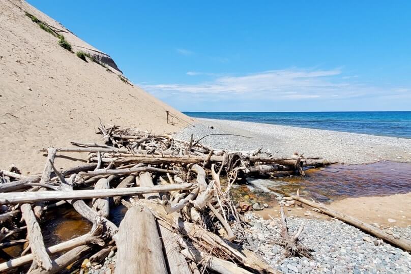 Sable Falls waterfalls river to Lake Superior beach in Pictured Rocks. UP Michigan travel blog