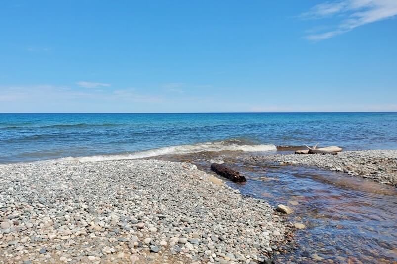 Sable Falls waterfalls river to Lake Superior beach in Pictured Rocks. UP Michigan travel blog