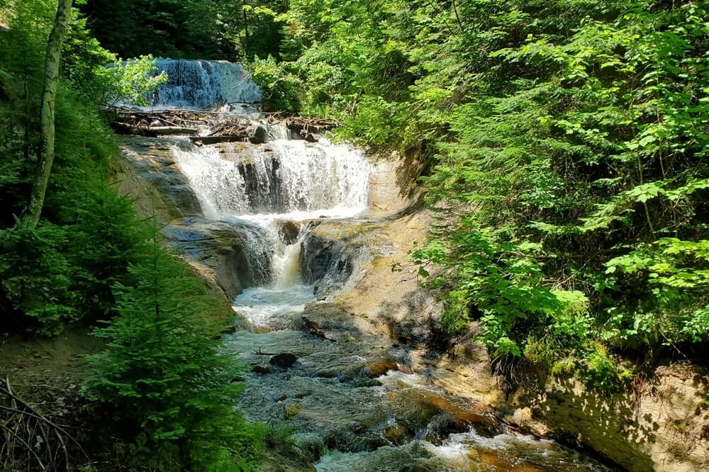 Best places to visit in the UP upper peninsula Michigan: Pictured Rocks National Lakeshore waterfalls. Michigan travel blog