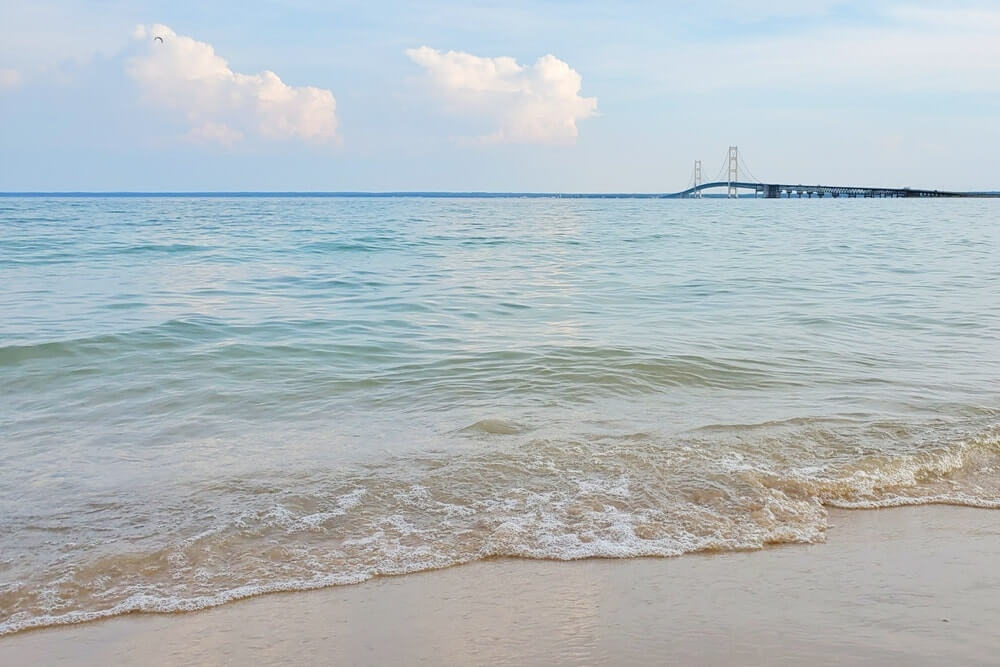 Best places to visit in the UP upper peninsula Michigan: Straits State Park campground with mackinac bridge views. Michigan travel blog