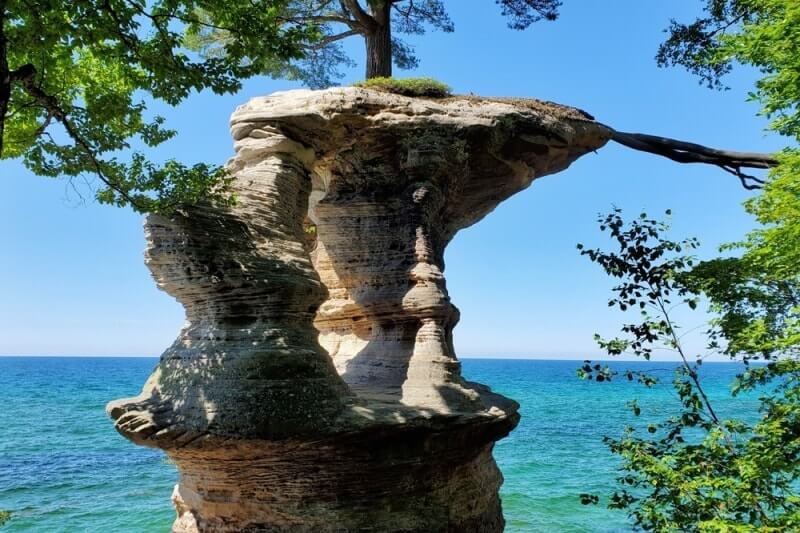 Things to do in Pictured Rocks National Lakeshore park: chapel rock, tree growing on a rock. UP Michigan travel blog