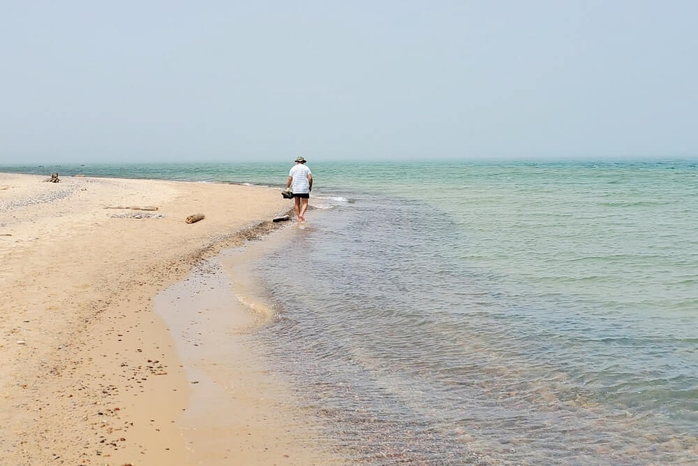 Whitefish Point beach near whitefish point lighthouse. Lake Superior lighthouse shipwreck coast. upper peninsula. up michigan travel blog