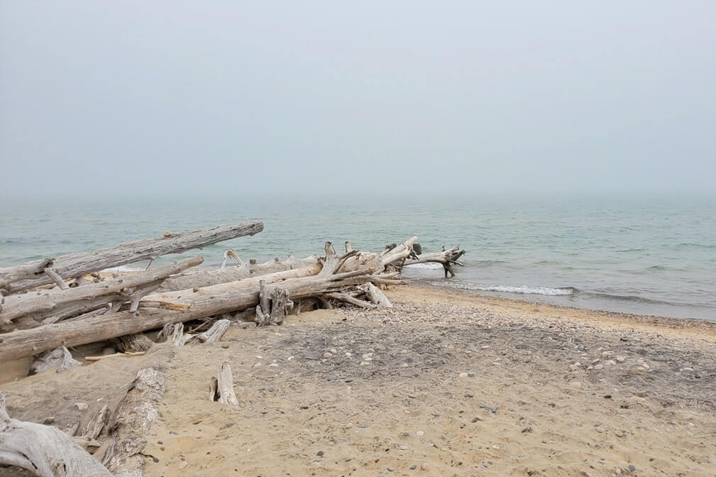 Whitefish Point beach near whitefish point lighthouse. Lake Superior lighthouse shipwreck coast. upper peninsula. up michigan travel blog