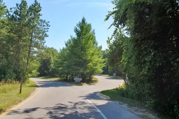 Driving Pierce Stocking Scenic Drive to get to Lake Michigan overlook parking. michigan travel blog