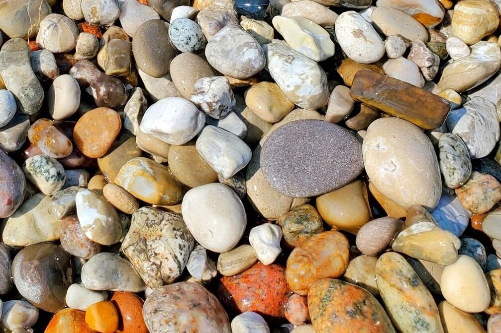 Lake Michigan rocks. Things to do in Sleeping Bear Dunes: Old Indian Trail beach colorful rocks. michigan travel blog