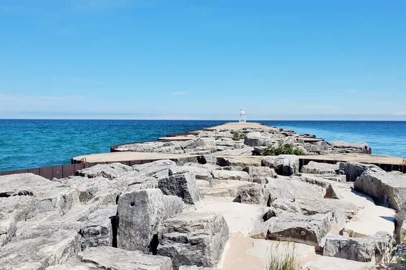 Grand Marais lighthouse pier walk. Lake Superior lighthouse pier. Grand Marais MI. grand marais harbor of refuge outer lighthouse. up michigan travel blog