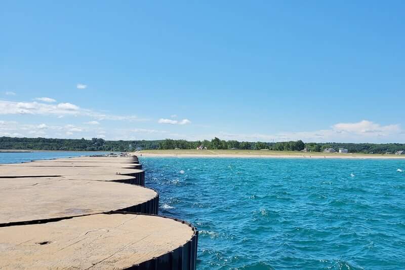 Grand Marais lighthouse pier walk. Lake Superior lighthouse pier. Grand Marais MI. grand marais harbor of refuge outer lighthouse. up michigan travel blog