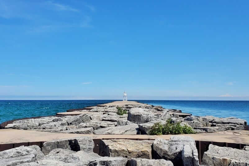 Grand Marais lighthouse pier walk. Lake Superior lighthouse pier. Grand Marais MI. grand marais harbor of refuge outer lighthouse. up michigan travel blog