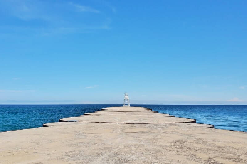 Grand Marais lighthouse pier walk. Lake Superior lighthouse pier. Grand Marais MI. grand marais harbor of refuge outer lighthouse. up michigan travel blog