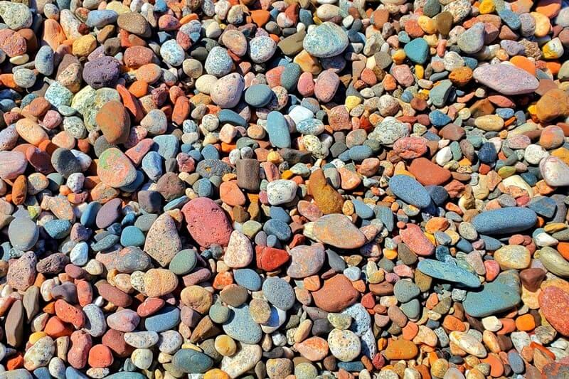 Grand Marais lighthouse beach near outer lighthouse pier. Lake Superior agate rocks. grand marais agate beach. colorful rocks. up michigan travel blog
