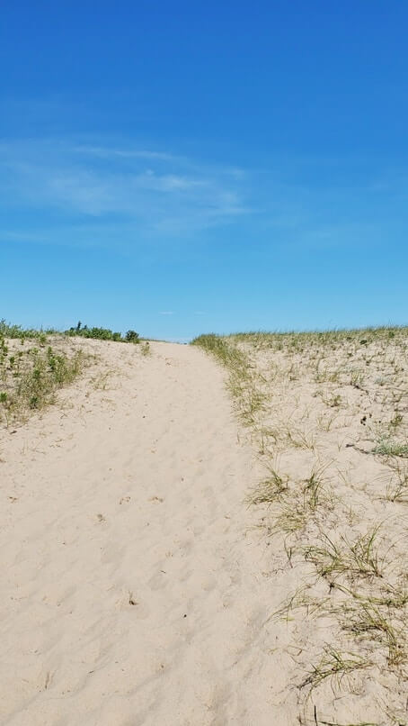Sand dunes in Grand Marais MI. grand sable dunes. lake superior sand dunes. Getting to Grand Marais lighthouse pier. getting to grand marais harbor of refuge outer lighthouse pier. lake superior. grand marais MI lighthouses. up michigan travel blog