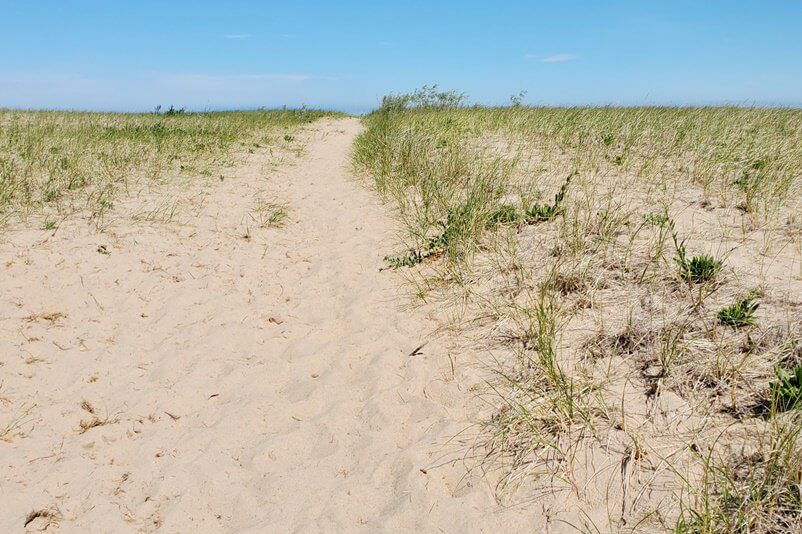 Sand dunes in Grand Marais MI. grand sable dunes. lake superior sand dunes. Getting to Grand Marais lighthouse pier. getting to grand marais harbor of refuge outer lighthouse pier. lake superior. grand marais MI lighthouses. up michigan travel blog