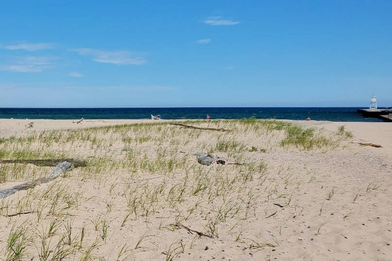 Sand dunes in Grand Marais MI. grand sable dunes. lake superior sand dunes. Getting to Grand Marais lighthouse pier. getting to grand marais harbor of refuge outer lighthouse pier. lake superior. grand marais MI lighthouses. up michigan travel blog
