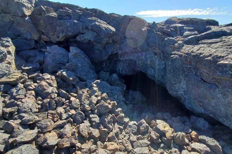 cave entrance of beauty cave lava tube. craters of the moon. idaho travel blog