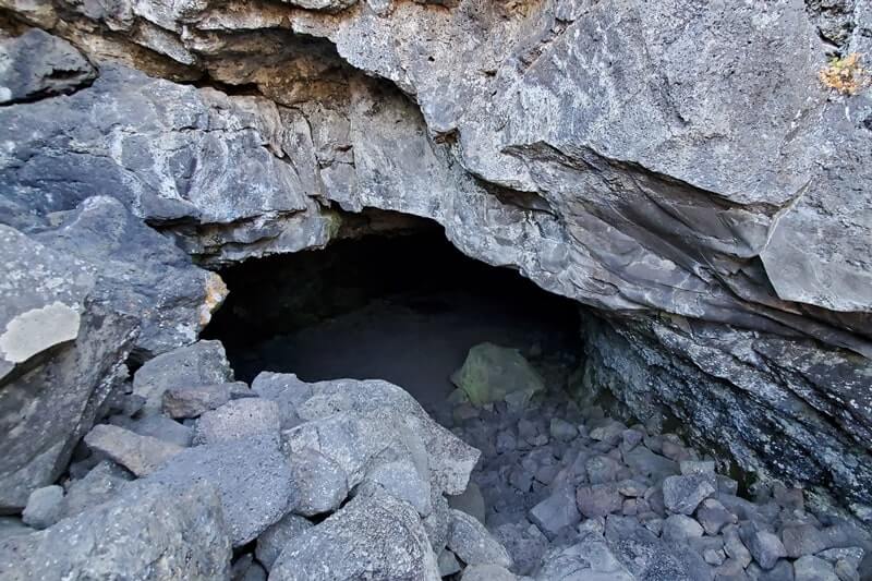 cave entrance of beauty cave lava tube. craters of the moon. idaho travel blog