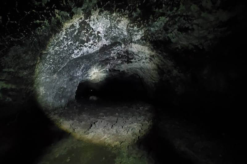 walking inside beauty cave lava tube. craters of the moon. idaho travel blog