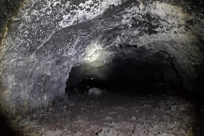 walking inside beauty cave lava tube. craters of the moon. idaho travel blog