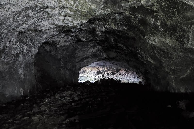 walking inside beauty cave lava tube. craters of the moon. idaho travel blog