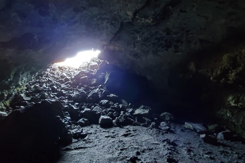 walking inside beauty cave lava tube. craters of the moon. idaho travel blog