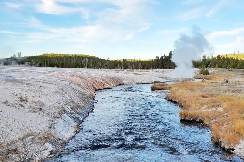 black sand basin geyser eruption on a creek. creek geyser in yellowstone. similar to river geyser in yellowstone. wyoming travel blog