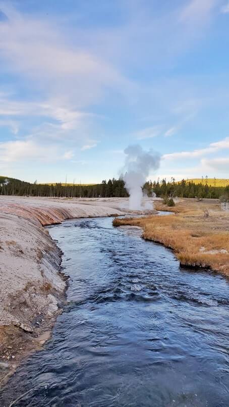 black sand basin geyser eruption on a creek. creek geyser in yellowstone. similar to river geyser in yellowstone. wyoming travel blog