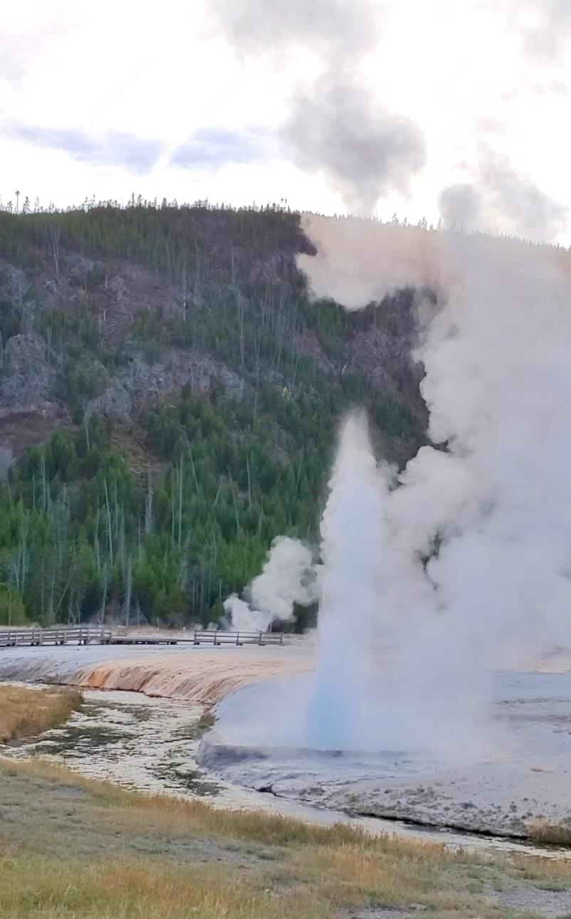 black sand basin geyser eruption. creek geyser in yellowstone. similar to yellowstone river geyser. Is the Black Sand Basin worth it? where to see creek geyser in yellowstone national park. wyoming travel blog