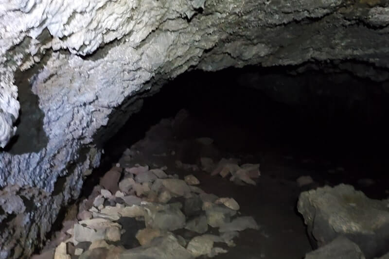Inside Boy Scout Cave: Where to see a lava tube in Idaho. Craters of the moon lava tube. Craters of the moon caves in Idaho. idaho travel blog