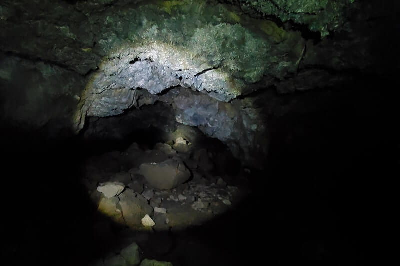 walking through boy scout cave lava tube. craters of the moon. idaho travel blog