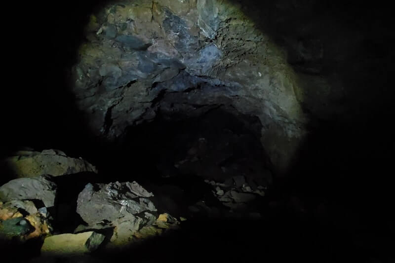 walking through boy scout cave lava tube. craters of the moon. idaho travel blog