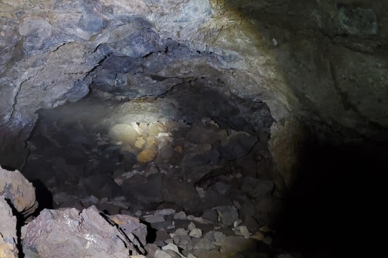 walking through boy scout cave lava tube. craters of the moon. idaho travel blog