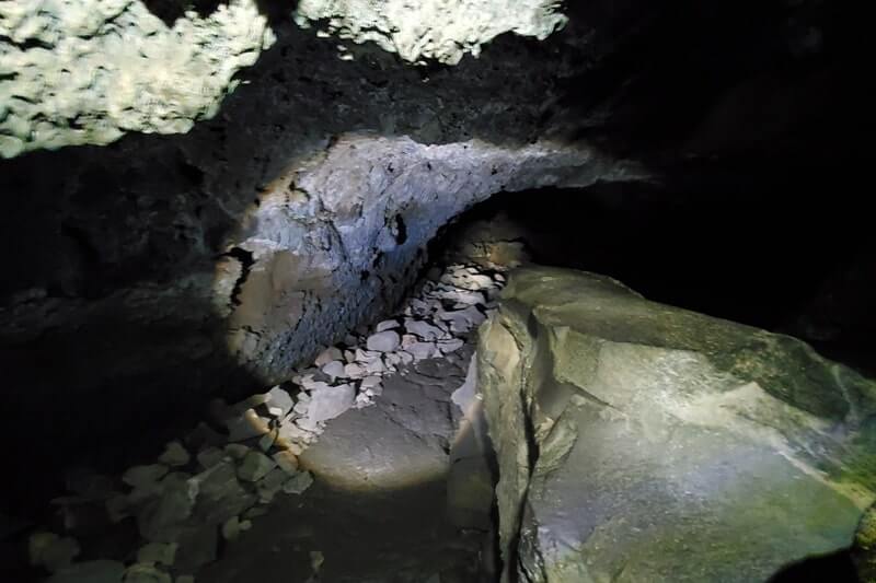 walking through boy scout cave lava tube. craters of the moon. idaho travel blog