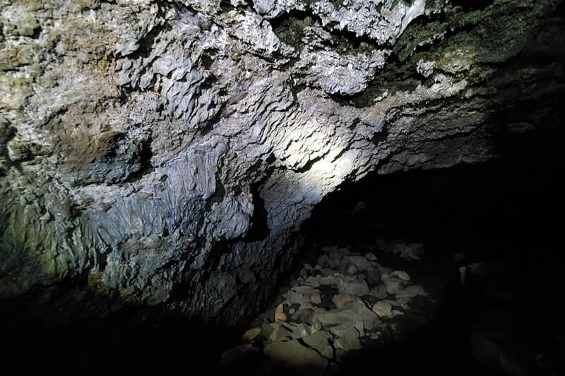 walking through boy scout cave lava tube. craters of the moon. idaho travel blog