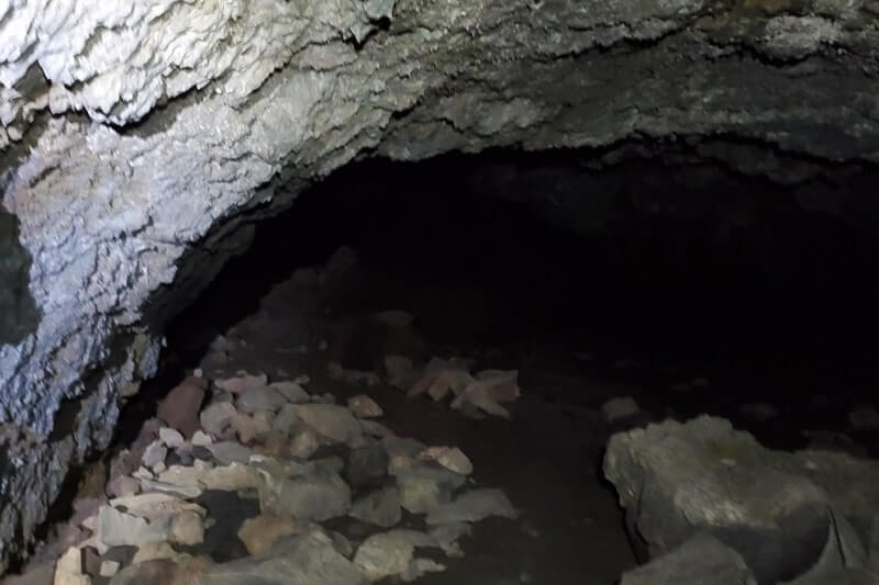 walking through boy scout cave lava tube. craters of the moon. idaho travel blog