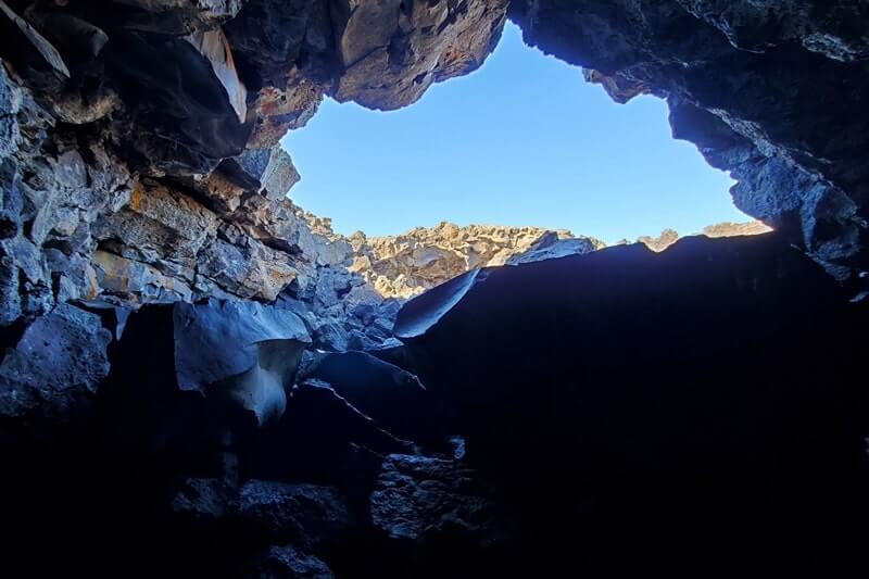 Inside Dewdrop Cave: Where to see a lava tube in Idaho. Craters of the moon lava tube. Craters of the moon caves in Idaho. idaho travel blog