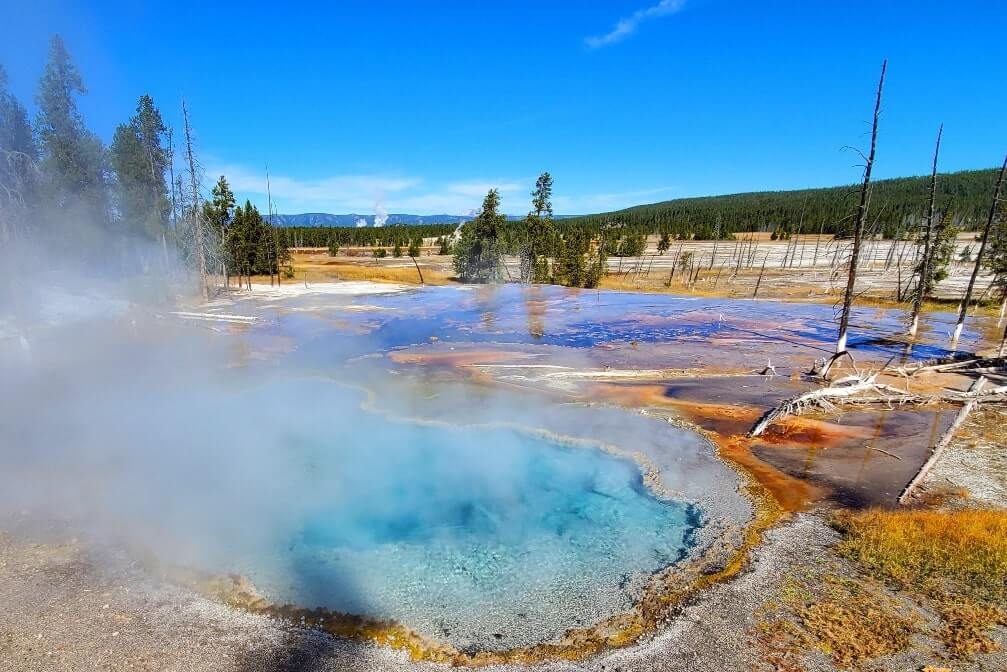 Firehole Spring in Yellowstone National Park. Hot springs in Yellowstone. Yellowstone steam. wyoming travel blog