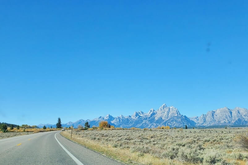 Driving the 42-mile scenic loop road in Grand Teton National Park: Driving through Grand Teton National Park from elk ranch flats to snake river overlook, north to south. wyoming travel blog