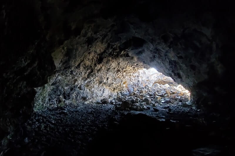 walking through indian tunnel lava tube. craters of the moon tunnel. idaho travel blog