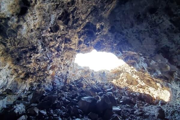 walking through indian tunnel lava tube. craters of the moon tunnel. idaho travel blog