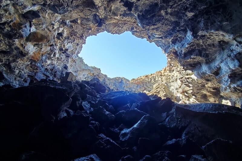 walking through indian tunnel lava tube. craters of the moon tunnel. idaho travel blog