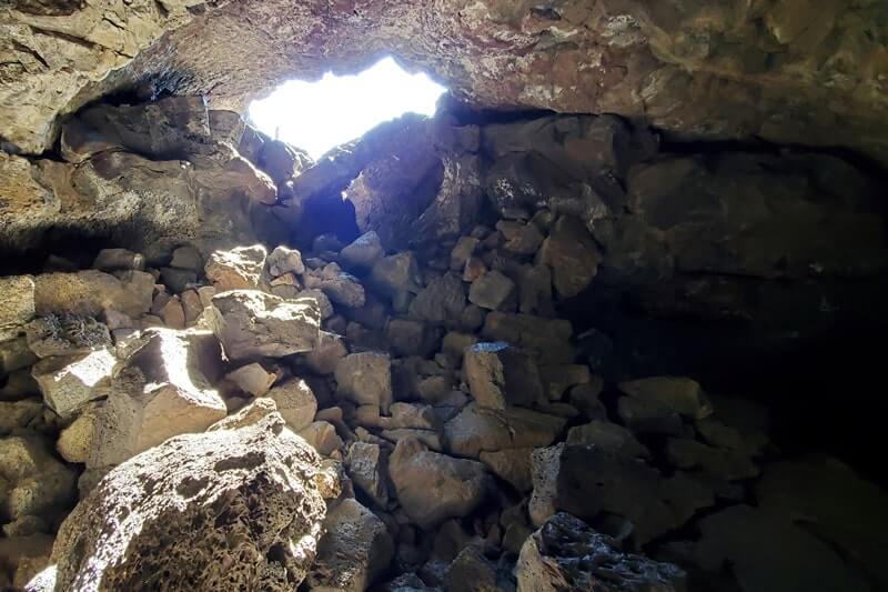 walking through indian tunnel lava tube. craters of the moon tunnel. idaho travel blog