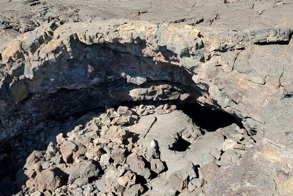 climbing out of indian tunnel lava tube. craters of the moon tunnel. idaho travel blog