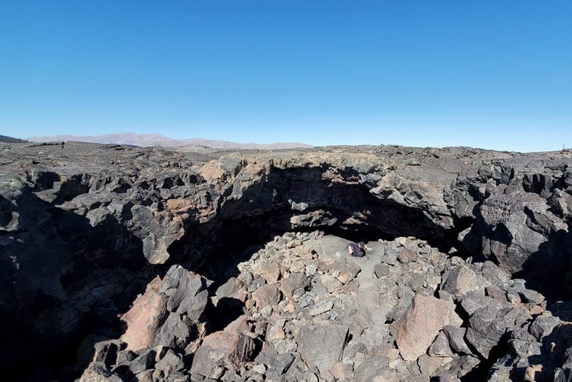 climbing out of indian tunnel lava tube. craters of the moon tunnel. idaho travel blog