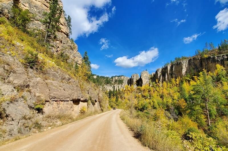 Stops to make when driving from Mount Rushmore to Roughlock Falls to Devils Tower: roughlock falls road. south dakota to wyoming