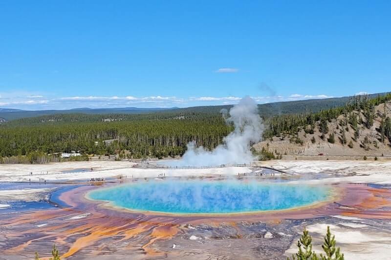 7 days in Wyoming road trip: colorful hot spring in yellowstone national park, grand prismatic spring. devils tower to yellowstone. wyoming travel blog