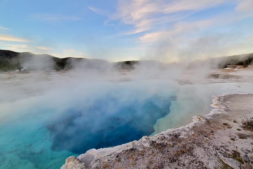 sapphire pool: bright blue yellowstone hot spring in biscuit basin. wyoming travel blog