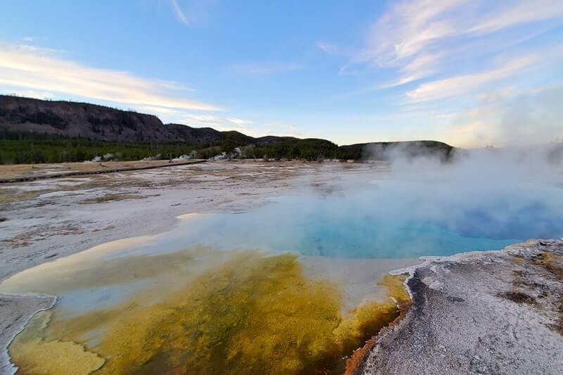 sapphire pool: bright blue yellowstone hot spring in biscuit basin. wyoming travel blog
