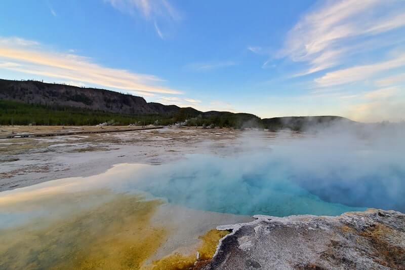 sapphire pool: bright blue yellowstone hot spring in biscuit basin. wyoming travel blog