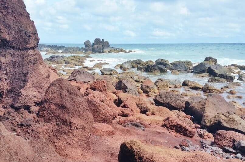 Things to do in Hana: hana beach. red sand in hana. koki beach. maui hawaii travel blog